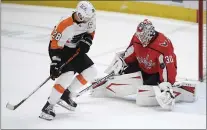  ?? NICK WASS - THE ASSOCIATED PRESS ?? Flyers captain Claude Giroux, left, seen here wishing the puck would pop out from Washington Capitals goaltender Ilya Samsonov on Tuesday night, suffered through a case of COVID during the season but says that shouldn’t be an alibi for the way his team has played.