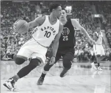  ?? FRANK GUNN, THE CANADIAN PRESS ?? Raptors’ DeMar DeRozan drives past Los Angeles Clippers’ Austin Rivers in the first half in Toronto on Monday night. Toronto won, 118-109.