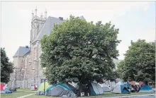  ?? JESSICA NYZNIK EXAMINER ?? Tents cover the lawn of Emmanuel United Church after many of those who had been camping in Victoria Park moved locations.