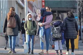  ?? SETH WENIG/AP FILE ?? Children and their caregivers arrive for school March 7 in New York. COVID-19 cases are starting to rise again in the United States, with numbers up in most states and up steeply in several.