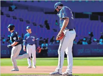  ?? FRANK GUNN THE CANADIAN PRESS ?? Jays’ Joe Biagini, right, reacts as Rays’ C.J. Cron rounds the bases after hitting a homer in the eighth Sunday.