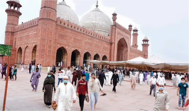  ?? Associated Press ?? ↑
People leave the historical Badshahi mosque after offering Friday prayers during the holy month of Ramadan in Lahore.