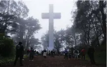  ?? Associated Press ?? ■ People gather Sunday at the Mount Davidson cross in San Francisco. Mount Davidson’s annual Easter Sunrise Service was canceled for San Francisco’s shelter-in-place orders over coronaviru­s concerns.