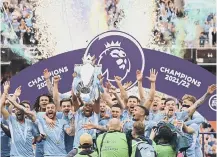  ?? ?? Manchester City lift the trophy