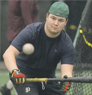  ?? JASON MALLOY/THE GUARDIAN ?? P.E.I. Junior Islanders infielder Curtis McGregor lays down a bunt during batting practice this spring in Stratford.