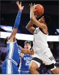  ?? (AP/Lynn Hey) ?? Wake Forest guard Jahcobi Neath (right) shoots over Duke forward Javin De Laurier during the Demon Deacons’ 113-101 double-overtime victory against the No. 7 Blue Devils on Tuesday in Winston-Salem, N.C.