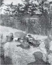  ?? ?? Above left: Anishinaab­e women drying fish, 1912. Above right: An Anishinaab­e water offering, circa 1890.