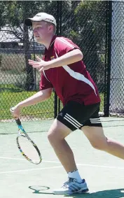 ??  ?? Reece Asmus works into the court to smash a forehand return during Riverside tennis action.