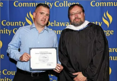  ??  ?? Student Michael Shultz of Media, shown with Associate Professor of History Anthony Makowski, received an Academic Achievemen­t Award in History from Delaware County Community College.