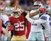  ?? RAY CHAVEZ — BAY AREA NEWS GROUP ?? The 49ers’ Elijah Mitchell stiff arms Dallas Cowboys’ Malik Hooker in the fourth quarter of a NFC divisional-round playoff game at Levi’s Stadium in Santa Clara on Sunday.