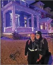  ?? SUBMITTED PHOTO ?? Two people that participat­ed in a Christmas lights run in Boyertown stop to take a photo in front of a lit-up house.