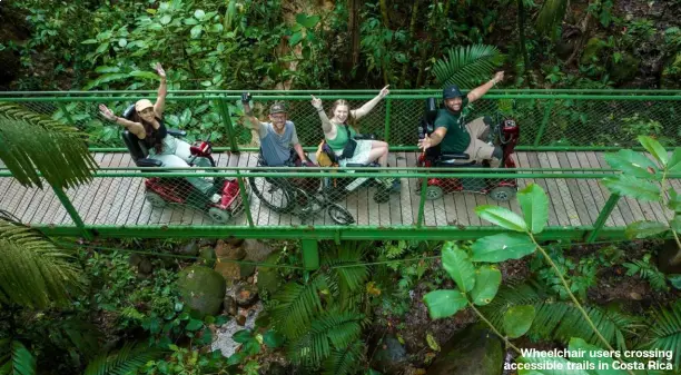  ?? ?? Wheelchair users crossing accessible trails in Costa Rica