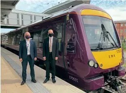  ??  ?? East Midlands Railway managing director Will Rogers and Rail Minister Chris Heaton-harris stand alongside emission trial DMU 170513 at Derby station on July 1. EMR