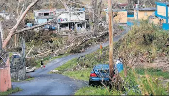  ?? GERALD HERBERT/AP 2017 ?? Damage can be seen in Yabucoa, Puerto Rico, in the days after Hurricane Maria struck in September 2017. The U.S. said Friday it is sending nearly $13 billion to the island territory.
