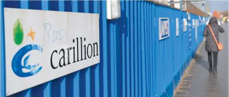  ??  ?? A Carillion sign is defaced with the word 'bust' on a hoarding at the collapsed company's constructi­on site at the Royal Liverpool University Hospital, UK. (AFP)