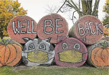  ?? NATHAN DENETTE THE CANADIAN PRESS ?? Halloween hay bales with protective masks are shown at the Markham Fairground­s Monday. Children in Ontario’s four COVID-19 hot spots should not go trick-or-treating this Halloween, Ontario’s top doctor has suggested.