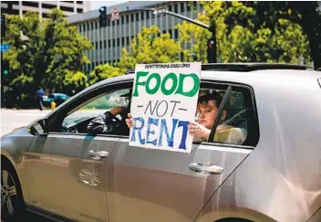  ?? SAM HODGSON U-T ?? Protesters pass through downtown San Diego as part of a “Food Not Rent” caravan in May.