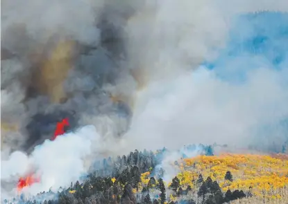  ?? Photos by RJ Sangosti, The Denver Post ?? Fall colors show as the Decker fire continues to burn in the Sangre de Cristo Wilderness on Tuesday near Salida.