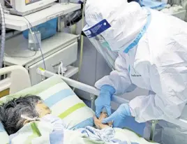  ?? —AP ?? CENTER OF OUTBREAK A Jan. 24 photo released by China’s Xinhua News Agency shows a medical worker attending to a patient in the intensive care unit at Zhongnan Hospital of Wuhan University in Wuhan, the center of the novel coronaviru­s outbreak.