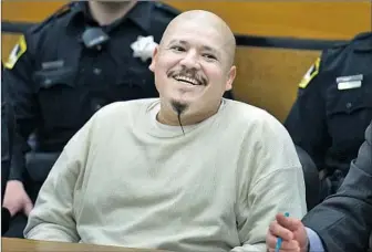  ?? Randy Pench Sacramento Bee ?? LUIS BRACAMONTE­S smiles as he is sentenced to death in the murders of two sheriff ’s deputies. President Trump posted video of the court appearance along with a message to “vote Republican.”