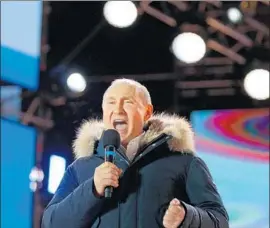  ?? Alexander Zemlianich­enko Pool Photo ?? RUSSIAN President Vladimir Putin speaks at a concert that had been widely seen as a victory event. He was expected to win more than 70% of Sunday’s vote.