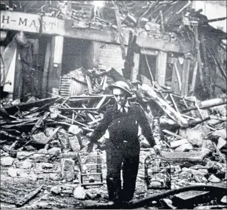  ??  ?? Air raid warden in Clydebank rescues pet birds during the Blitz in March 1941