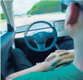  ?? DREAMSTIME 2019 ?? A man uses Autopilot technology in a Tesla. Federal officials are looking into a string of recent accidents in which the technology was or may have been used.