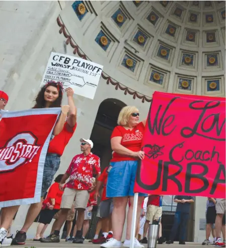  ?? GETTY IMAGES ?? Supporters of Ohio State football coach Urban Meyer display signs during a rally earlier in the week in Columbus, Ohio.