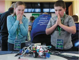  ??  ?? The pressure is intense as team mates Anna Gleeson and Noah Connell from Monaleen watch their robot do battle at the Analog Devices Primary School Robotics Championsh­ip