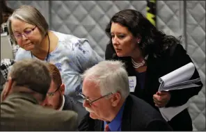  ?? AP/CHRIS O’MEARA ?? Democratic Party observer Rachel May Zysk (right) checks on volunteers examining ballots Friday in Tampa, Fla., during a manual recount.