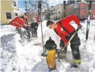  ?? THE ASSOCIATED PRESS ?? Portland, Maine, firefighte­rs Andrew Johnston, left, Lt. Don Brown, center, and David Young clear snow from around one of the city’s 1,500 fire hydrants on Wednesday.