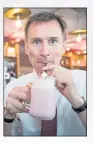  ??  ?? Jeremy Hunt drinks a milkshake during a visit to Chelsmford in Essex on Wednesday