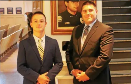  ?? OSCAR GAMBLE — DIGITAL FIRST MEDIA ?? Newly sworn-in Norristown police officers Robert Nolan, left, and Matthew Walsh, right, stand in front of the portrait of fallen Norristown Officer Thomas Barone at Municipal Hall shortly after taking their oaths in front of family and friends, Wednesday, Aug. 9.