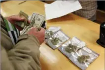  ?? MATHEW SUMNER — THE ASSOCIATED PRESS ?? A customer purchases marijuana at Harborside marijuana dispensary Monday in Oakland, California.