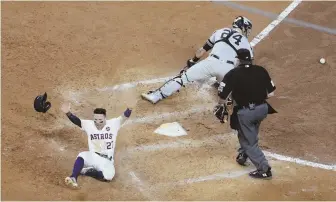  ?? AP PHOTOS ?? SAFE AT HOME: Astros star Jose Altuve celebrates after sliding safely past Yankees catcher Gary Sanchez (24) to score the game-winning run in the bottom of the ninth to beat the Yankees, 2-1, in yesterday’s Game 2 of the ALCS in Houston. Below, Houston...