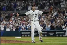  ?? MARTA LAVANDIER — THE ASSOCIATED PRESS ?? Japan pitcher Shohei Ohtani celebrates after defeating the United States at the World Baseball Classic final game Tuesday in Miami.
