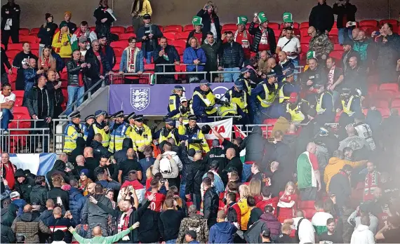  ?? Picture: Nick Potts/PA ?? Hungary fans clash with police during this week’s FIFA World Cup qualifying match at Wembley. Columnist Ian Holloway writes that he was ‘sickened’ by the incidents which he said were a ‘throwback to the sort of violence we saw at our football grounds during the 1970s and 80s’