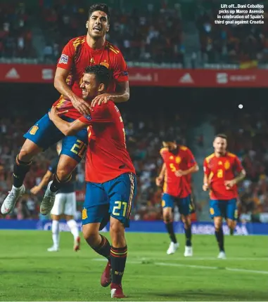  ??  ?? Lift off...Dani ceballos picks up Marco Asensio in celebratio­n of Spain’s third goal against croatia