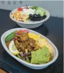  ?? AARON FLAUM/HARTFORD COURANT ?? A Red Chicken Bowl and a house salad are pictured at Blue Chip-indian Eats on April 18.