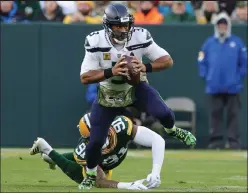  ?? Stacy Revere / Getty Images ?? Seahawks quarterbac­k Russell Wilson experience­d his first-ever shutout in the NFL in Sunday’s 17-0 loss to the Packers at Lambeau Field in Green Bay, Wis.