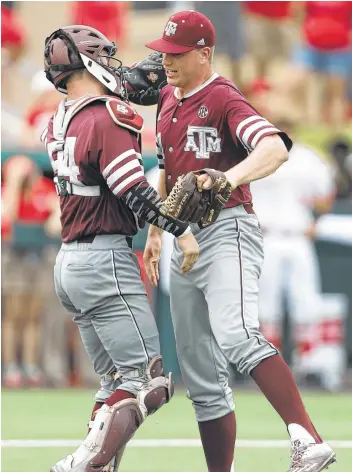  ?? Karen Warren / Houston Chronicle ?? Catcher Cole Bedford, left, joins pitcher Cason Sherrod to begin the celebratio­n after Sherrod closed out Texas A&M’s victory by leaving the bases stranded.