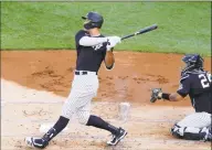  ?? Kathy Willens / Associated Press ?? The Yankees’ Aaron Judge follows through on a solo home run off James Paxton during an intrasquad game on Wednesday.