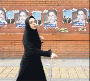  ?? MAJID SAEEDI / GETTY ?? Una mujer, ante carteles electorale­s en Teherán, la semana pasada