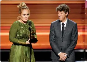  ?? ?? Adele and Greg Kurstin took home the Grammy for song of the year in 2017 for “Hello.”