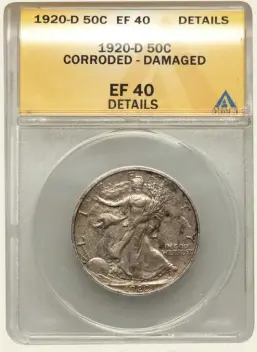  ?? Photo courtesy Heritage Auctions. ?? A 1920-D Walking Liberty half dollar in an ANACS holder labeled “Corroded - Damaged.”