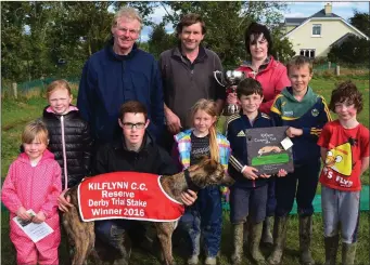  ??  ?? Timmy Carmody and the Costello family after their dog won the Reserve Derby Trial Stakes in Kilflynn last Sunday. Photo by David O’Sullivan