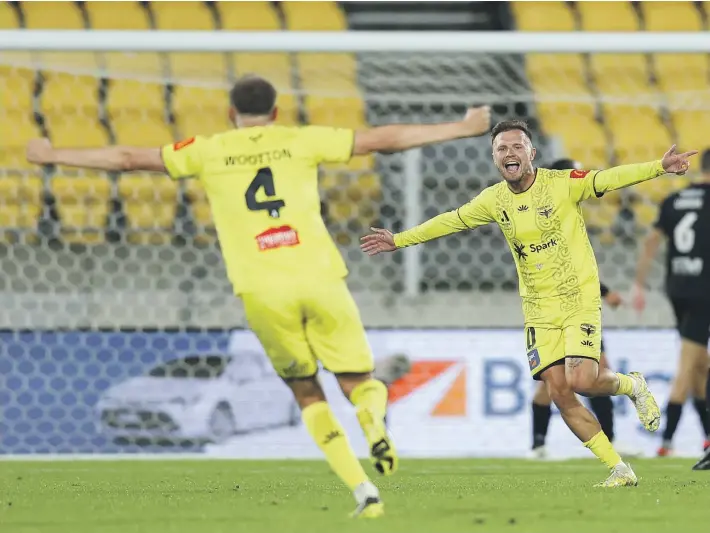  ?? ?? David Ball of the Phoenix celebrates Tim Payne’s goal as the Phoenix defeated Macarthur 3-0 in Wellington last night. The Phoenix did their job but the result between Premiers Plate rivals the Mariners and the Jets didn’t go the Wellington team’s way, meaning a wait to decide the A-League silverware. GETTY