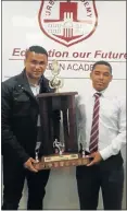  ??  ?? BLAZING BOOTS: Urban Academy U19 soccer manager Kagan Assam and captain Austin Joel with the trophy they won in their first show at the NMMU Charity Cup last month. Under coach Lukhanyo Wasa, Urban Academy – opened in 2003 – beat Uitenhage’s Strelitzia...