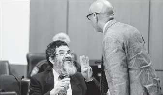  ?? Melissa Phillip / Houston Chronicle ?? Ali Mahwood-Awad Irsan talks with his defense attorney, Rudy Duarte. Irsan, 60, is charged with capital murder, accused of killing his daughter’s husband and her best friend, an Iranian activist.