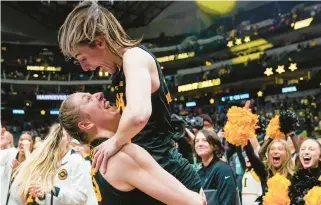  ?? TONY GUTIERREZ/AP ?? Iowa star Caitlin Clark, right, and teammate Monika Czinano celebrate after the Hawkeyes upset South Carolina 77-73 Friday night in Dallas to advance to the championsh­ip game.